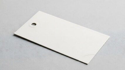 Minimalist Presentation of a Blank Rectangular Tag on a Textured Surface