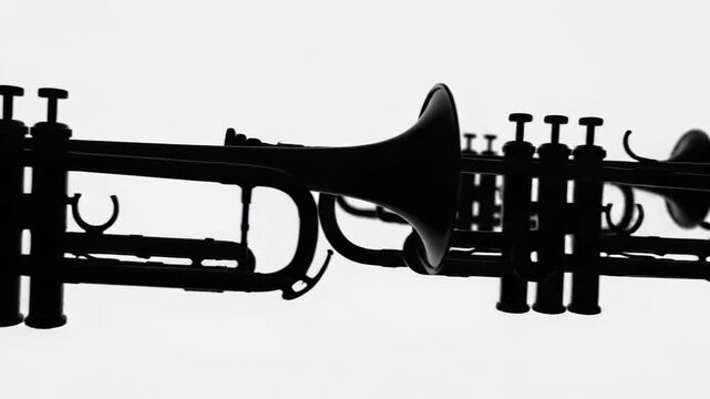 Silhouette of trumpet musical instrument against bright white background