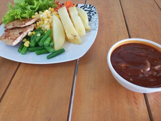Grilled Chicken Steak with Boiled Potatoes and Mixed Vegetables on Wooden Table