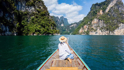 Serene boat ride on Cheow Lan Lake surrounded by stunning limestone cliffs in Khao Sok Thailand