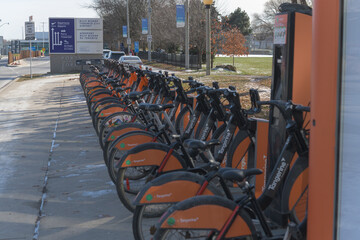 Fototapeta premium looking south on Eireann Quay incl sign at Billy Bishop Toronto City Airport and Bike Share docking station