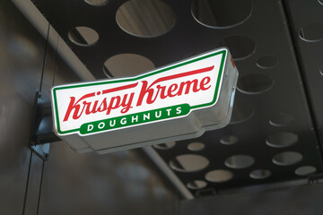 Fototapeta premium projecting logo sign outside Krispy Kreme Café, a donut shop, located at 105 Dundas St E, Toronto