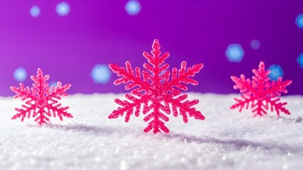 Vibrant pink snowflakes on snowy surface with purple background and falling snow