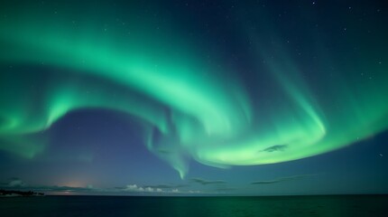 Fototapeta premium Aurora Borealis painting the night sky with vibrant green light over a calm body of water under a starry expanse