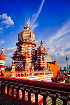 Spectacular view of the historic Minarets of the Jami Ul Alfar Mosque in contrast with the landmark 351m tall Lotus Tower with bright blue skies in Colombo,Sri Lanka