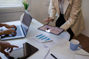 Business meeting. analyst team utilizing BI Fintech to analyze financial report with laptop....