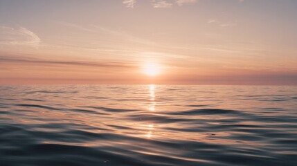 A serene sunset over calm ocean waters, reflecting warm hues of orange and pink, creating a peaceful atmosphere.
