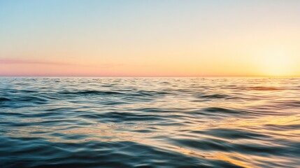 Obraz premium A serene ocean view at sunset, showcasing gentle waves and a colorful sky, evoking tranquility and natural beauty.