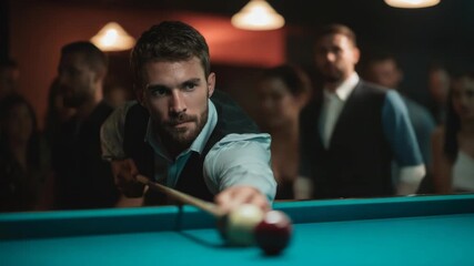Handsome man concentrating aiming to shoot pool ball at billiard table