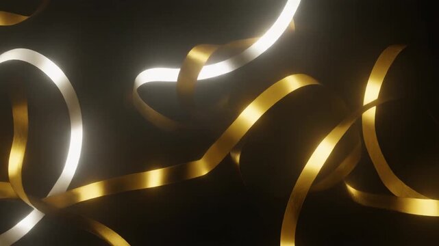 Elegant Gold and Silver Ribbons Twirling in Soft Light against a Dark Background