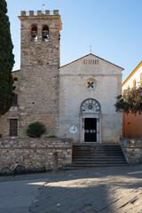 The Romanesque Pieve di San Giusto in Suvereto, Tuscany. The stone church features a simple facade with an arched portal and an imposing bell tower, typical of medieval Italian religious architecture