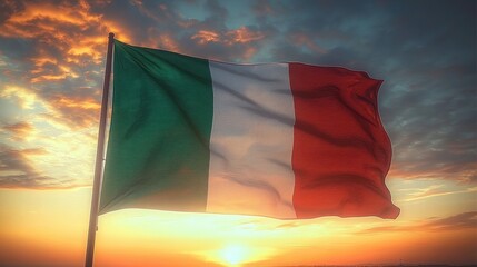 A flag with vertical green, white, and red stripes waving against a dramatic sunset sky with clouds and warm sunlight