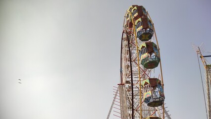 Ferris Wheel with blue sky, festival attraction and adventure