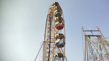 Ferris Wheel with blue sky, festival attraction and adventure