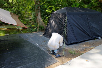 Camping Setup Near a Stream in a Forest
