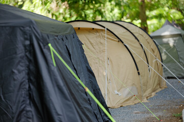 Row of Different Camping Tents Pitched at a Gravel Campsite
