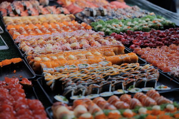 Colorful assorted sushi rolls at Asian street food market