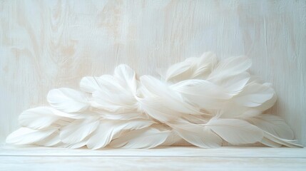 Pile of soft white feathers arranged delicately on a light wooden surface with a pale wooden background evoking a calm and gentle mood