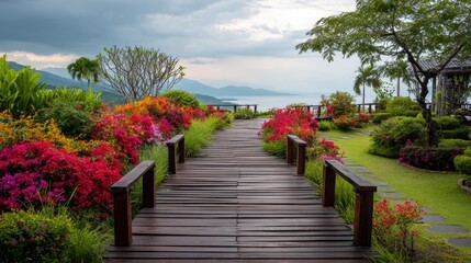 Obraz premium Walking Path Leads Through Blooming Bushes and Flowers to an Open Sky Seen in the Distance Near a Garden Area in a Coastal Setting