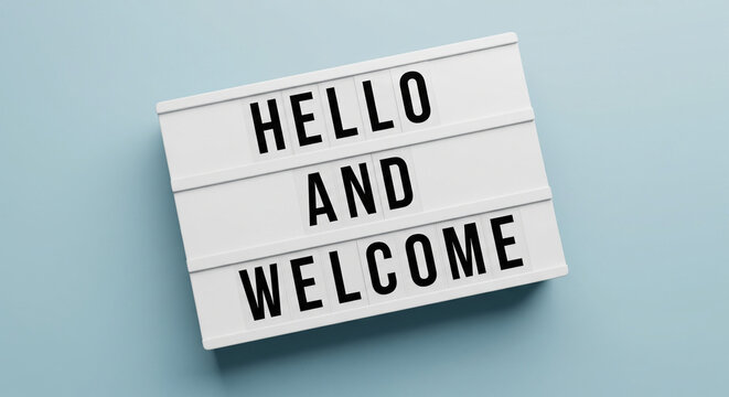White lightbox sign displaying the text "HELLO AND WELCOME" against a soft blue background.