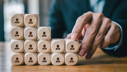 Building staircase of wooden blocks with human figures symbolizes teamwork and collaboration in professional setting