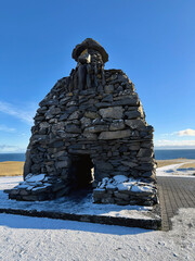  B&aacute;r&eth;ur Sn&aelig;fells&aacute;s Statue on the Sn&aelig;fellsnes Peninsula, featuring sweeping views of the ocean, mountains, and dramatic coastal cliffs in western Iceland. 