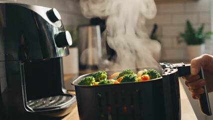 Hot steamy vegetables removed from air fryer basket