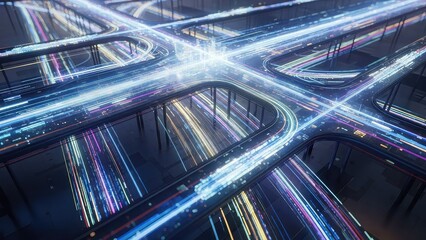 Aerial view of a busy highway interchange at night with colorful light trails on roads and bridges