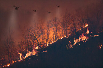 Group of 4 Firefighting Drones  spraying chemical agents to control a wildfire on a mountain at night.