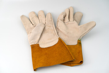 A pair of protective work gloves crafted from a combination of natural leather and suede leather, ideal for welding, construction, and industrial applications. Displayed on a white background