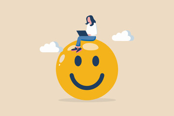 A woman working on a laptop atop a large cheerful yellow smiley face