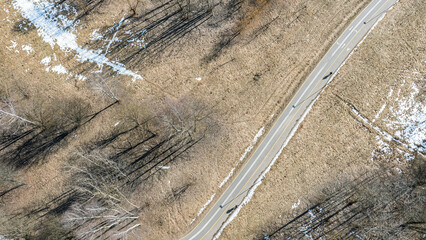 footpath and bicycle lane in the public park at sunny spring day. aerial view from flying drone.