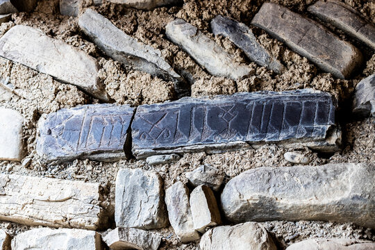 Carved inscriptions on a stone forming part of the mosque wall in Xinaliq, Azerbaijan