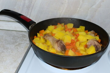 Homemade food. Stewed potatoes in a frying pan.