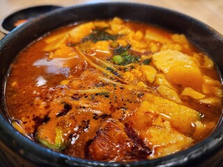 Spicy Korean Stew With Tofu, Potatoes, and Greens in Rich Red Broth