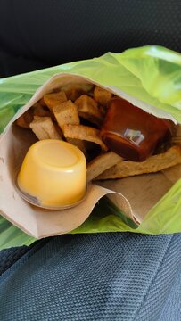 Famous Malaysian food especially in Malaysia east coast. Made from fresh fish. 'Keropok Lekor' in paper bag with chili sauce and cheese.