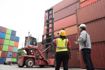 Cargo container and Import, export , Worker control reach stacker at container yard. Group of...