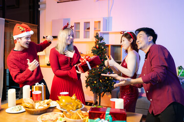 Friends capture the holiday spirit with gifts, laughter, and a festive Christmas dinner in a cozy, joy-filled setting.