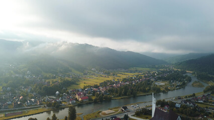 Serene rural valley with fog and sunrise glow