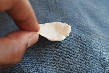 closeup of removing gum from a pant 