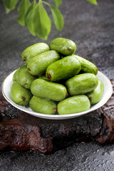 Fresh Green Jujubes on White Plate with Leaves