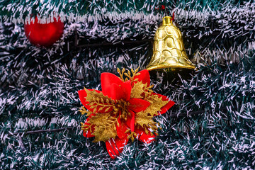 Close-up of a beautifully decorated ornament hanging on a artificial Christmas tree.