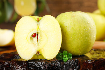 Fresh Yellow Apples Cut in Half with Water Droplets