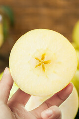 Fresh Yellow Apple Half in Hand - Crisp Healthy Fruit