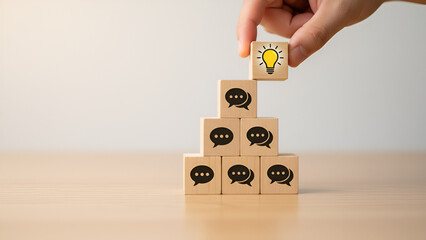 Creative teamwork concept with stacked wooden blocks and a hand placing a skull icon &mdash; business strategy, small team collaboration, problem-solving

