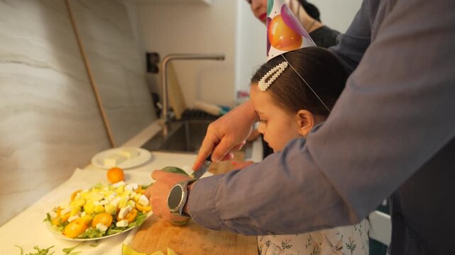 Matzah, Seder, Passover: Child participates in Seder plate preparation during Passover celebration.