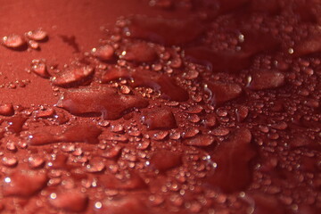 Water droplets on red wet texture