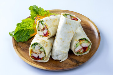 Chicken breast with caesar dressing and lettuce in a gluten-free tortilla wrap, tasty food