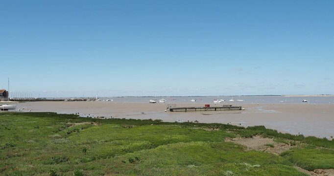 North beach of Fouras-les-Bains facing the Charente estuary and south of La Rochelle. The Fum&eacute;e headland lighthouse, its jetty, carrelets and the marina