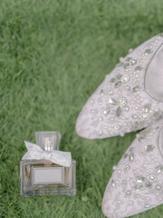 wedding shoes and perfume on green grass